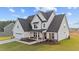 New construction two-story home with a 2-car garage, manicured lawn and charming front porch at 66 Tennyson Dr, Garner, NC 27529