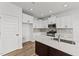 Bright kitchen with white cabinetry, stainless steel appliances, and a kitchen island at 66 Tennyson Dr, Garner, NC 27529