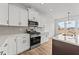 Modern kitchen with white cabinets, stainless steel appliances and island at 66 Tennyson Dr, Garner, NC 27529