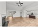 Spacious living room with fireplace and hardwood floors, flowing into the kitchen and dining area at 66 Tennyson Dr, Garner, NC 27529
