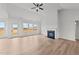 Bright living room featuring a fireplace, ceiling fan, and wood-look flooring throughout at 66 Tennyson Dr, Garner, NC 27529