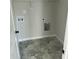 This laundry room features stylish geometric tile flooring and utility hookups at 69 N Movado Trl, Kenly, NC 27542