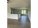 Living room with a bar area and large windows, offering plenty of natural light at 69 N Movado Trl, Kenly, NC 27542