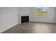 Living room fireplace with a modern mantel and hardwood floors at 7565 Michelle Rd, Rocky Mount, NC 27803