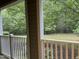 Relaxing backyard view from the porch, featuring lush trees and a green lawn at 814 Providence Glen Dr, Chapel Hill, NC 27514