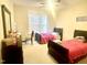 Cozy bedroom with two beds, bright natural light, and a ceiling fan at 814 Providence Glen Dr, Chapel Hill, NC 27514
