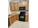 A well-equipped kitchen with wooden cabinets and black appliances at 814 Providence Glen Dr, Chapel Hill, NC 27514