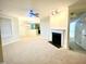 Spacious living room with neutral carpet, fireplace, and ceiling fan at 814 Providence Glen Dr, Chapel Hill, NC 27514