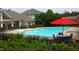 Community pool with clear blue water, umbrellas, and lounge chairs for relaxation at 814 Providence Glen Dr, Chapel Hill, NC 27514