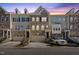 Three story townhouses with attached garages and front landscaping at 8352 Primanti Blvd, Raleigh, NC 27612