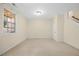 Bright and spacious living room with neutral carpeting and large window at 8352 Primanti Blvd, Raleigh, NC 27612