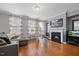 Living room features hardwood floors, fireplace and large windows at 8352 Primanti Blvd, Raleigh, NC 27612
