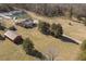 Aerial view of a house, barn, and pond on a large lot at 8437 Charlie Stovall Rd, Oxford, NC 27565