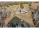 Aerial view showing house, pond, and detached barn on a spacious property at 8437 Charlie Stovall Rd, Oxford, NC 27565