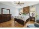 Comfortable bedroom with wood floors and wood accent wall at 8437 Charlie Stovall Rd, Oxford, NC 27565