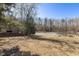 Serene pond view with a wooden dock and cabin at 8437 Charlie Stovall Rd, Oxford, NC 27565