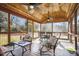 Relaxing screened porch with wooden ceiling and outdoor furniture at 8437 Charlie Stovall Rd, Oxford, NC 27565