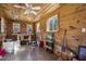 Rustic interior studio with wood walls and large windows at 8437 Charlie Stovall Rd, Oxford, NC 27565