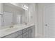 Bathroom with double sink vanity with grey cabinets and gold fixtures, along with a large mirror at 88 Tennyson Dr, Garner, NC 27529