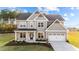 Two-story house with gray siding, white trim, and a two-car garage at 88 Tennyson Dr, Garner, NC 27529