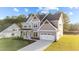 Two-story house with gray siding, white trim, and a two-car garage at 88 Tennyson Dr, Garner, NC 27529