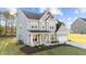 Attractive two-story home boasts gray siding, a welcoming porch, and a convenient two-car garage at 88 Tennyson Dr, Garner, NC 27529