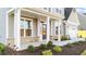 Front entrance with a dark door, white columns, and brick accents at 88 Tennyson Dr, Garner, NC 27529