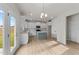 Modern kitchen with white cabinets and an island at 88 Tennyson Dr, Garner, NC 27529
