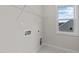 Laundry room with shelving, a utility sink, and a window at 88 Tennyson Dr, Garner, NC 27529