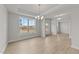Open living room with recessed lights, hardwood floors, and a large window overlooking the front yard at 88 Tennyson Dr, Garner, NC 27529
