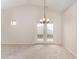 Dining area with vaulted ceiling, chandelier, and French doors at 9104 Colony Village Ln, Raleigh, NC 27617