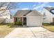 Brick ranch home with attached garage and landscaped yard at 9104 Colony Village Ln, Raleigh, NC 27617