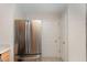 Kitchen with stainless steel refrigerator and access to hallway at 9104 Colony Village Ln, Raleigh, NC 27617