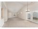 Spacious living room with vaulted ceiling, carpet, and access to backyard at 9104 Colony Village Ln, Raleigh, NC 27617