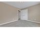 Bedroom with a view of closet and bathroom, featuring neutral-colored walls at 924 Bentbury Way, Cary, NC 27518