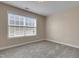 Bedroom with large window and neutral colored carpet at 924 Bentbury Way, Cary, NC 27518