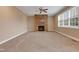 Comfortable carpeted living room with stone fireplace and ceiling fan for relaxation at 924 Bentbury Way, Cary, NC 27518