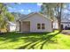 Newly constructed home with a grassy backyard and small patio at 1007 N King Ave, Dunn, NC 28334