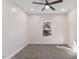 Well-lit bedroom with ceiling fan and carpet flooring at 1007 N King Ave, Dunn, NC 28334
