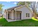 Newly built home with grey siding, spacious patio, and green lawn at 1007 N King Ave, Dunn, NC 28334
