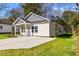 Newly built home with gray accents, a paved driveway, and a well-manicured lawn at 1007 N King Ave, Dunn, NC 28334