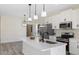 Modern kitchen with white cabinets, stainless steel appliances, and quartz countertops at 1007 N King Ave, Dunn, NC 28334