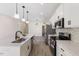 Modern kitchen with white cabinets, stainless steel appliances and a large island at 1007 N King Ave, Dunn, NC 28334