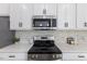 Stainless steel appliances and white cabinets highlight this modern kitchen at 1007 N King Ave, Dunn, NC 28334