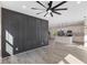 Spacious living area with stylish wall features, hardwood floors, and a ceiling fan at 1007 N King Ave, Dunn, NC 28334