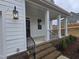 Brick steps and porch with black metal railing lead to the front entrance at 1013 Prominence Dr., Homesite 22, Durham, NC 27712
