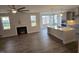Open floor plan with kitchen island, fireplace, and hardwood floors at 1013 Prominence Dr., Homesite 22, Durham, NC 27712
