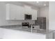Kitchen features white cabinets and granite countertops at 103 Scoville St, Oxford, NC 27565