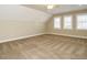 Bonus room featuring three windows and a ceiling fan at 116 Telluride Trl, Garner, NC 27529