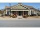 Community clubhouse exterior; attractive green building with porch and landscaping at 116 Telluride Trl, Garner, NC 27529